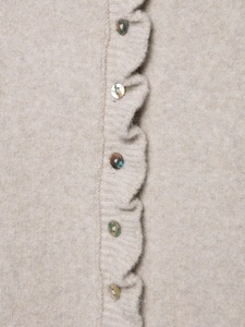 Macro shot of oat-beige knit cardigan with ruffled trim and iridescent shell buttons