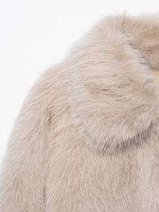 Detail shot of fluffy faux fur jacket collar in elegant champagne beige textured fabric