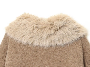 Detailed close-up of khaki wool jacket featuring a plush faux fur collar and textured fabric