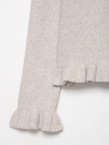 Detailed view of oatmeal knit cardigan featuring ruffled cuffs and soft wool blend texture