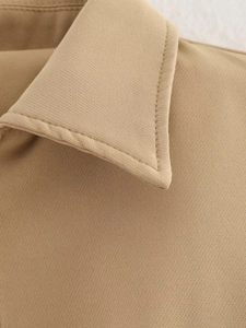 Close-up of the khaki twill fabric texture and high-quality stitching on the collar