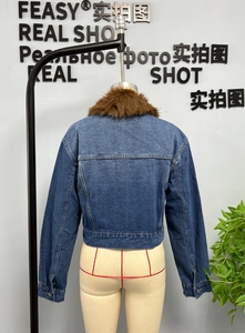 Back view of short denim jacket featuring a plush brown faux fur collar and neat stitching