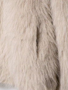 Macro shot of plush beige faux fur texture showing smooth and voluminous fiber details