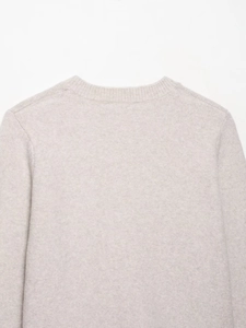 Close-up of the fine knit texture and neckline detail on oatmeal cashmere cardigan