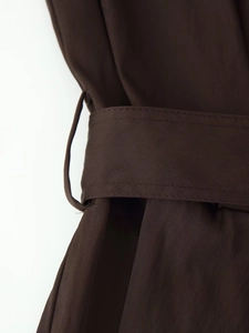 Close-up of the deep brown fabric belt and belt loop detail on a long sleeve midi dress