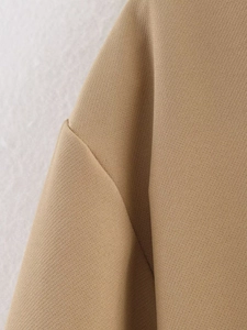Detailed view of the woven khaki fabric and professional shoulder stitching of the jacket