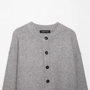 Classic grey knit cardigan with round neck and black buttons on white background