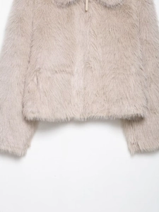 Close-up of beige faux fur texture on short winter jacket with soft plush finish