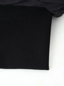 Macro detail of elastic ribbed knit cuffs on a premium black padded jacket