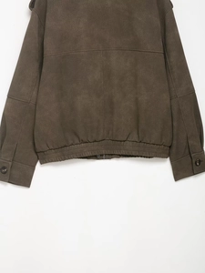 Detail shot of vintage faux suede jacket texture with ribbed hem and buttoned sleeve cuffs
