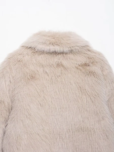 Detail of soft faux fur texture on the back collar of a beige fleece jacket