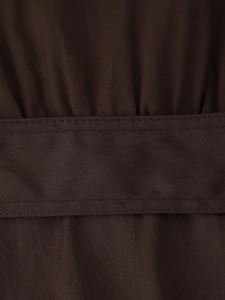 Detail of dark brown twill fabric showing double-stitched belt edge and premium texture