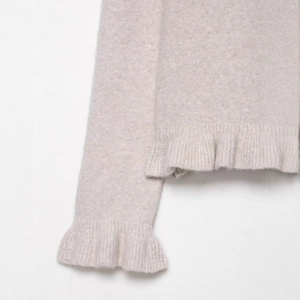 Chic oatmeal knit cardigan with layered ruffle cuffs and hem in premium wool texture