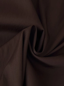 Macro detail of dark brown twill fabric texture with elegant pleated folds and silk finish