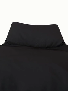 Close-up of the standing collar and smooth black synthetic fabric on this padded jacket