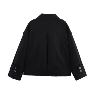 Detail view of the back of a black short trench jacket featuring back pleat and cuff straps