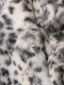 Detail shot of leopard print faux fur jacket showing the soft texture and logo metal plate