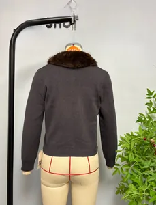Detail view of dark grey knit cardigan back with dark brown faux fur collar on mannequin