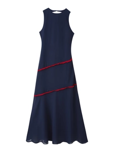 Detail of navy blue sleeveless maxi dress with contrasting red tassel trim and round neck