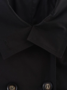 Close-up of black trench coat lapel with marbled buttons and fine fabric texture