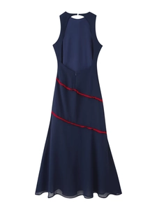 Detail view of the open-back navy dress with contrasting red ruffled fringe decorations