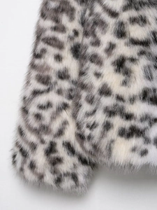 Close-up of premium leopard print faux fur fabric showing soft plush texture and pattern