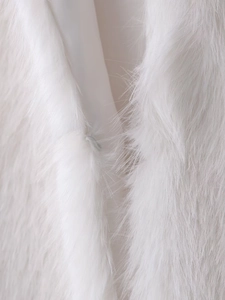 Detail of the hidden hook closure and soft white faux fur texture on this vest