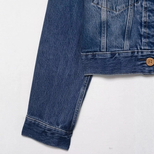 Deep blue denim jacket with faux fur trim featuring classic metal buttons and cuff details