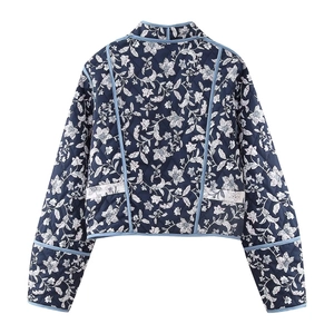 Detail view of floral quilted jacket back showing navy blue fabric and blue piping