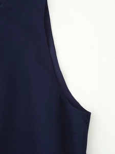Detailed view of the tailored armhole and stitching on the navy sleeveless dress