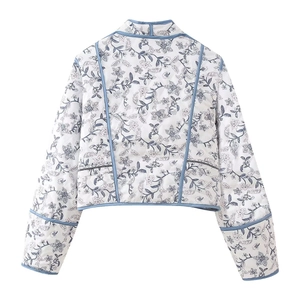 Detail of blue floral quilted jacket featuring diamond stitching and contrast piping