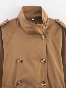 Close-up of khaki double-breasted trench coat showing lapels, epaulets and buttons