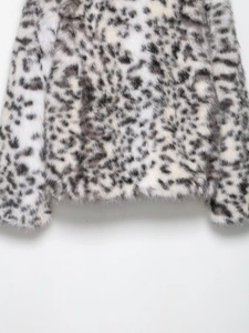 Detail of soft faux fur texture on leopard print jacket with plush animal pattern