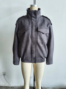 Detail view of charcoal suede jacket featuring shoulder epaulettes and large chest pockets