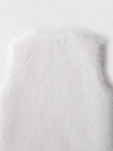 Close-up of white faux fur vest showing dense fluffy texture and soft luxurious fibers