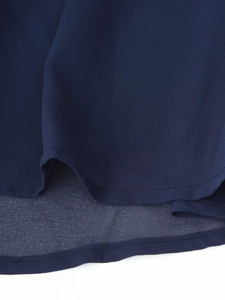 Detailed close-up of navy blue chiffon dress hem with double-layered stitching