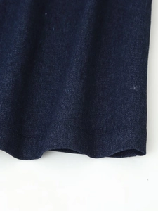 Detail shot of navy blue jacquard denim hemline with premium stitching and texture