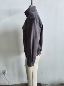 Detail view of dark grey faux suede jacket with stand collar and flap chest pockets