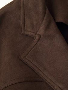Detailed close-up of dark brown faux suede jacket collar with neat double stitching