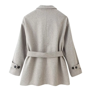 Detail view of the gray wool coat back with waist belt and buttoned cuffs
