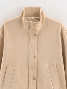 Detail of beige faux suede jacket showing stand-up collar and snap button closure