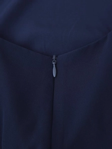 Detail of hidden zipper closure on navy blue dress with high-quality seamless stitching