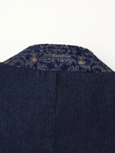 Detailed close-up of vintage golden floral jacquard on dark blue kimono collar fabric