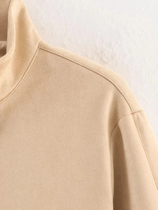 Detail of beige suede jacket collar and shoulder stitching with premium fabric texture