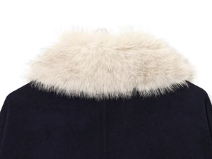 Detailed close-up of faux fur collar and wool blend fabric on a navy blue jacket