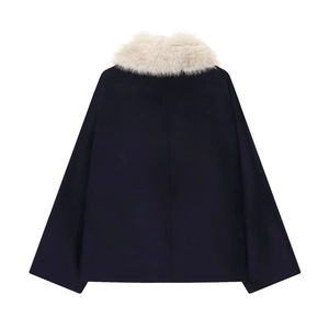 Detail view of navy blue wool coat back featuring a plush cream faux fur collar trim