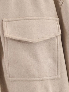 Detail of faux suede jacket showing a chest pocket with flap and double-stitch seams
