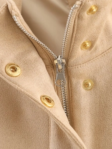 Detail of khaki suede jacket featuring metallic silver zipper and gold textured press buttons
