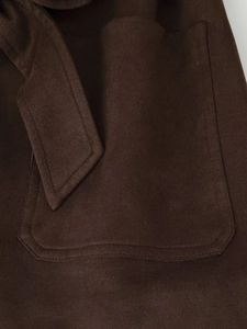 Detail view of coffee brown faux suede jacket with belt and large patch pocket