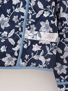 Close-up of diamond quilting and delicate floral prints on this vintage reversible jacket